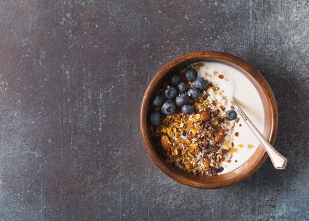 Homemade granola muesli with blueberries ondark grey background breakfast
