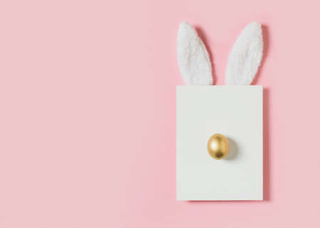 Easter mock up with rabbit and egg poster on pink background, copy space, flat lay, top view