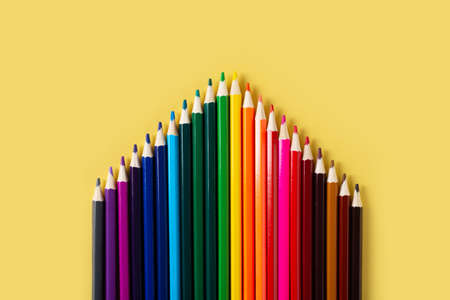 Group of colorful pencils gradation on yellow background, top view, flat lay, copy spaceの写真素材