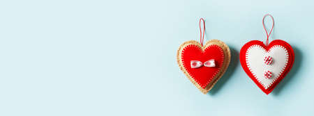 Handmade red textile heart on blue background, valentines day card, top view, copy space, bannerの写真素材