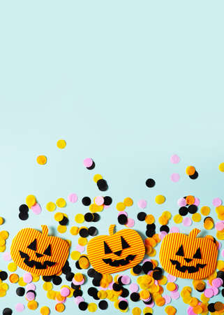 Kids halloween handmade paper pumpkins, creative, craft concept on blue background, top view, copy...