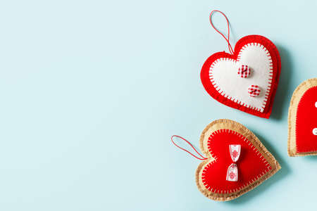 Handmade red textile heart on blue background, valentines day card, top view,の写真素材