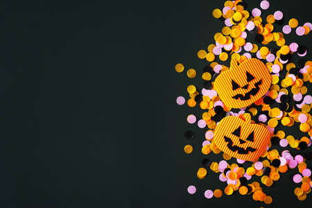 Kids halloween handmade paper pumpkins, creative, craft concept on black background, top view, copy space, borderの写真素材