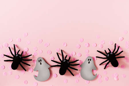 Halloween card with black spiders, grey ghost and confetti on pink backgroundの写真素材