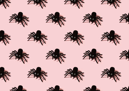 Seamless pattern with black toy spiders on pink backgroundの写真素材