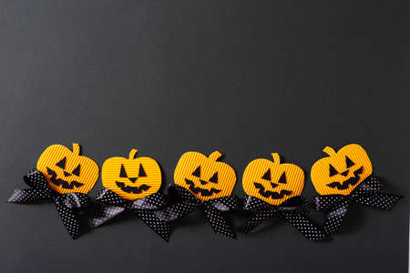 Kids halloween handmade paper pumpkins, creative, craft concept on black background, top view, copy spaceの写真素材