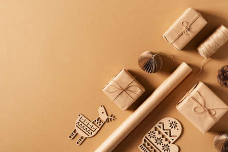 Craft paper gift box, christmas and happy new year concept, eco friendly packeging on brown, top view, copy spaceの写真素材