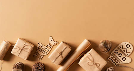 Craft paper gift box, christmas and happy new year concept, eco friendly packeging on brown, top view, copy spaceの写真素材