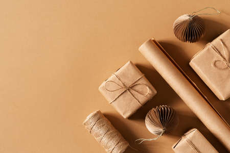 Craft paper gift box, christmas and happy new year concept, eco friendly packeging on brown, top view, copy spaceの写真素材