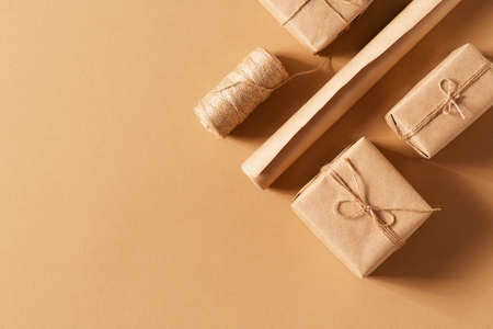 Craft paper gift box, christmas and happy new year concept, eco friendly packeging on brown, top view, copy spaceの写真素材