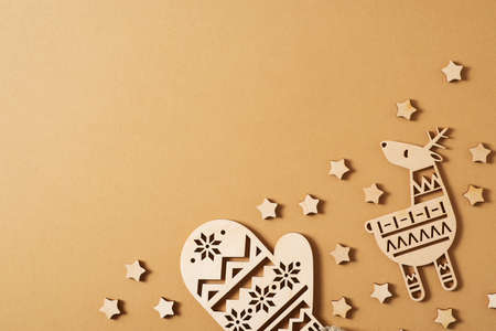 Christmas flat lay with wooden star and scandinavian eco toys on brown or gold background, copy space, flat lay, top viewの写真素材