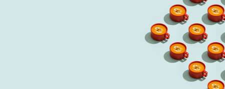 Autumn pumpkins soup with vegetables on blue backgroundの写真素材