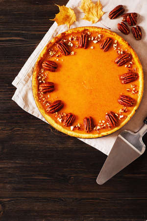 Traditional pumpkin pie on table, flat lay with pumpkinsの写真素材