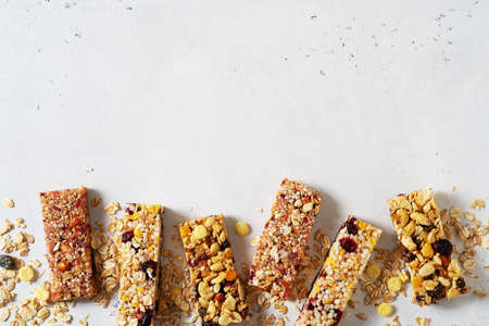 Nuts and oats energy mix bars on white background