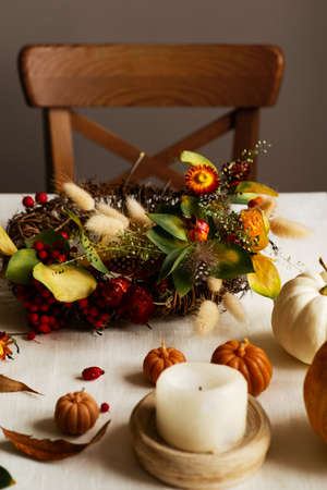 Flat lay with diy floral autumn wreath with driad grass, plant and berry