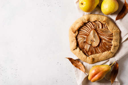 Pie or tart pear with spice on white background, top view, close upの写真素材