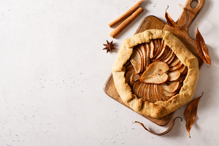 Pie or tart pear with spice on white background, top view, close upの写真素材