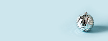 Disco ball celebration concept on blue background, copy space, bannerの写真素材