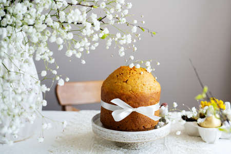 Handmade easter cake with white flowers and decor on table