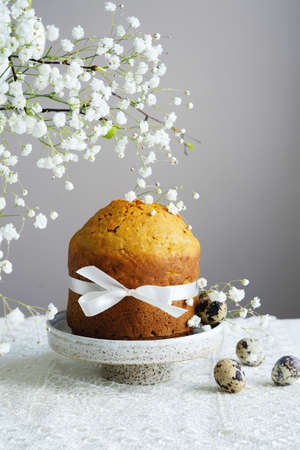 Handmade easter cake with white flowers and decor on table