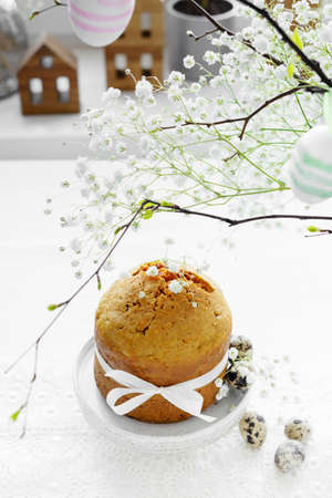Handmade easter cake with white flowers and decor on table