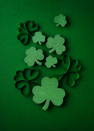 Saint Patrick day flat lay concept with shamrock clover on green background, top view, copy space,...