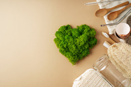 World earth day concept with green plant heart and eco friendly recycle items on beige background, flat lay, top viewの写真素材