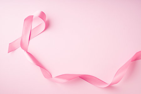 World breast cancer day concept with pink ribbon on pink background, top view, copy spaceの写真素材