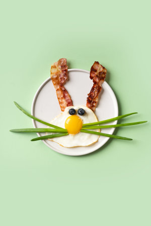 Easter concept with funny fried egg bunny and beconの写真素材