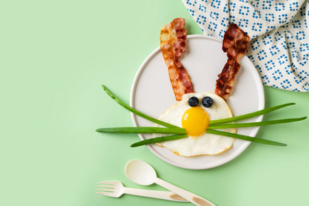 Easter concept with funny fried egg bunny and beconの写真素材