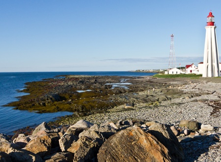 Rivage on the edge of the sea with a lighthouse boat and sound signal tower at the right side to image ( Pointe-au-PÃ¨re ) Rimouski,Quebec,Canadaの写真素材