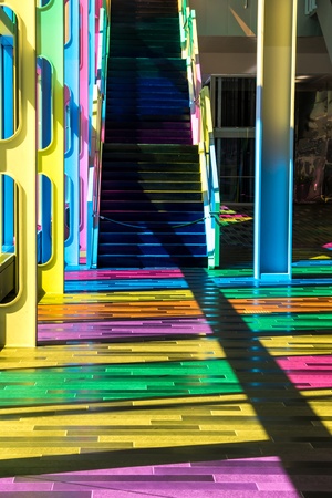 Different colors on the floor of the building and a staircase in the backgroundの写真素材