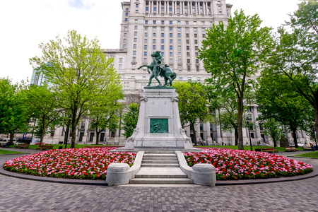 Commemorative Statue of A century of Cold War soldier holding his horse In a Dominion Park of Montreal in the Flowers Garden and in Old Building  のeditorial素材
