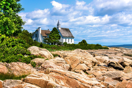 HDR Image Of An Old Abandoned church on the edge of the shore on a beautiful day in Charlevoix, Quebec, Canadaの写真素材