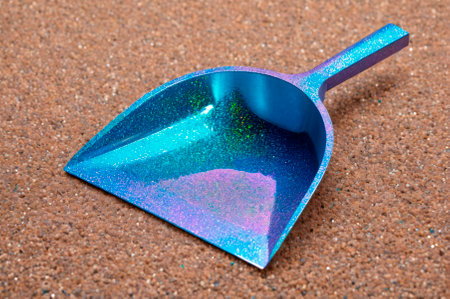 Sparkly Blue Dustpan on Sandy Surface. Generative AI.の写真素材