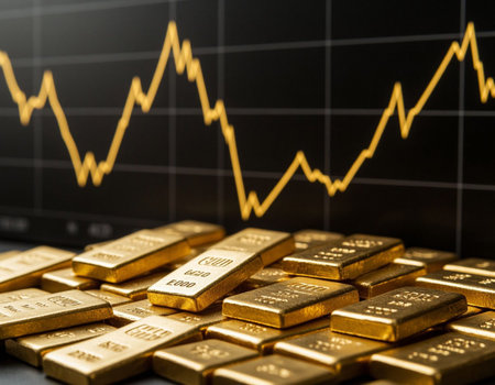Gold bullion bars and candlestick chart on the background.