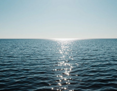 beautiful seascape with blue sky and sun reflection in waterの写真素材
