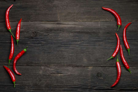 Red hot chili peppers on wooden background