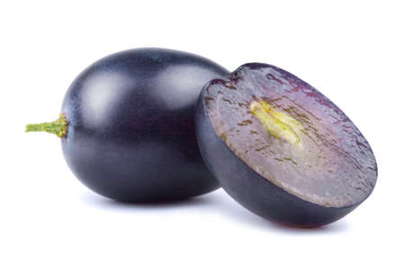 Dark blue grapes and grape slices isolated on white background.の写真素材