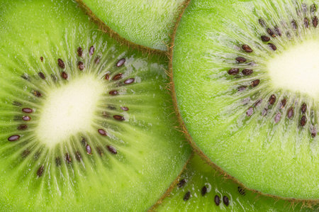 Juicy kiwi slices. Culinary green fruit background.の写真素材