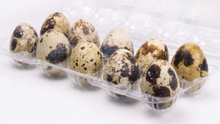 Quail eggs in a package on a white background. Culinary ingredients.の写真素材