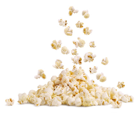 Falling cereal on a handful of popcorn isolated on a white background.の写真素材