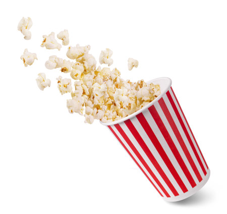 A striped bucket with flying popcorn isolated on a white background.の写真素材