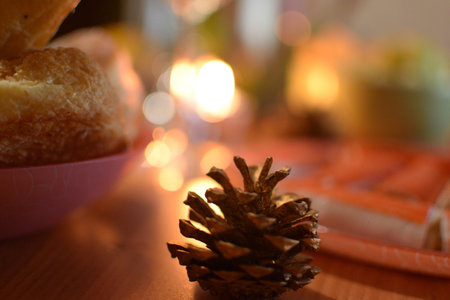 Christmas still life with pine cone, cookies and candles on wooden tableの写真素材
