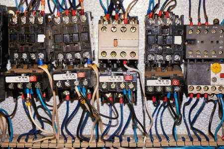 Some electrical relay is mounted on the mounting panel. Relays inserted in the base or socket. To the relay, wires connected with the terminals and marking.の写真素材