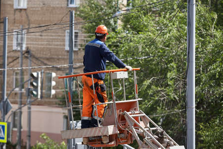 Installation of a traffic light on a lift in the afternoon in the city of Syzran Russia.の写真素材