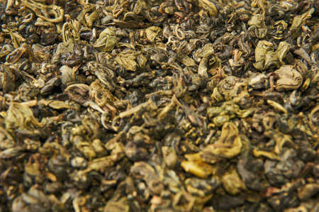 A pile of dry green tea. Isolated on white background.の写真素材