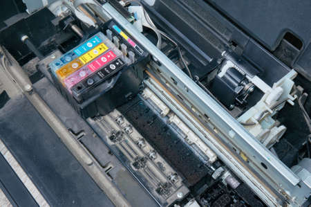 Old, dirty, disassembled ink jet printer. View of internal parts. Closeup