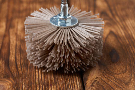 Grinding brush nylon for a drill for wood, on a wood background