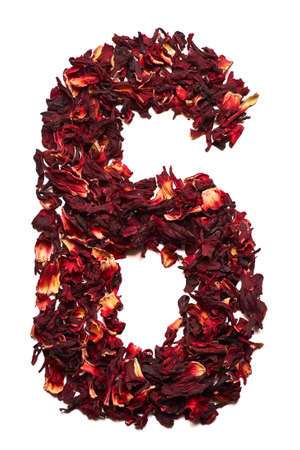 Number 6 from dried flowers of hibiscus tea on a white background. Number for banners, advertisements, menus.の写真素材